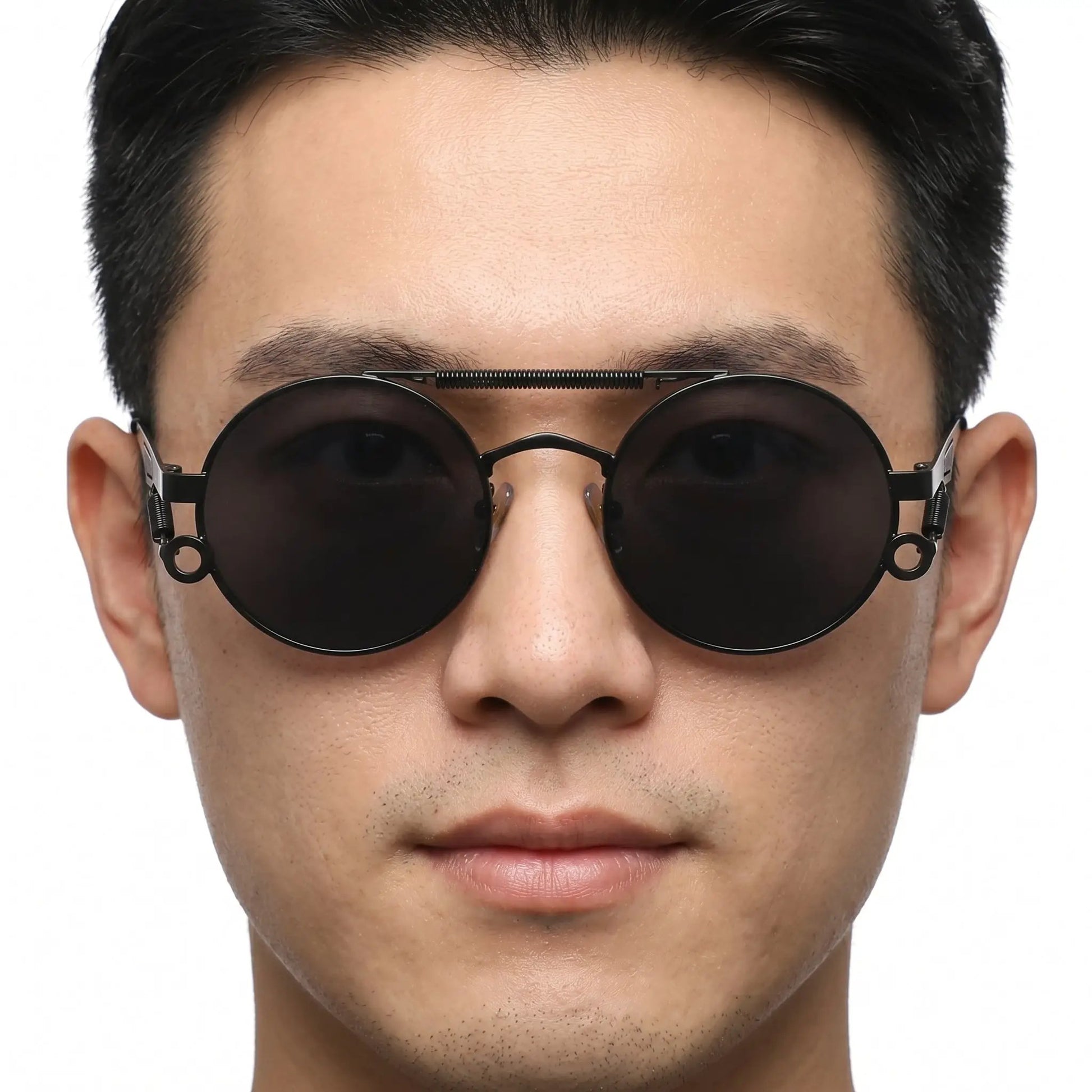 Noctis matte black metal round double-bridge sunglasses with dark lenses on a man's face – Astroshadez
