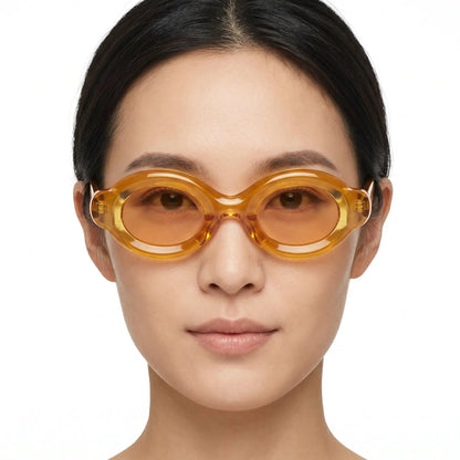 Elyndra Translucent Amber Oval Sunglasses with orange-tinted lenses and oversized rounded frames – Astroshadez